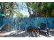 The fenced backyard offers an outdoor dining and lounging area with unique artistic touches at 1507 Legion Ln, Indian Rocks Beach, FL 33785