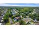 Wide aerial view of a residential neighborhood featuring homes with mature trees, landscaping and a pond at 1700 Azalea Ct # B, Oldsmar, FL 34677