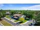 Aerial view of a two-story townhome with well-manicured lawns and mature trees in a residential area at 1700 Azalea Ct # B, Oldsmar, FL 34677
