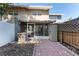 View of the backyard showing a brick-paved patio, fence, AC unit, storage shed, and the building's exterior at 1700 Azalea Ct # B, Oldsmar, FL 34677