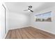 Neutral bedroom featuring a ceiling fan, closet and a window with outdoor views at 1700 Azalea Ct # B, Oldsmar, FL 34677