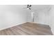 Minimalist bedroom with a ceiling fan, ensuite bathroom and light wood-look floors at 1700 Azalea Ct # B, Oldsmar, FL 34677