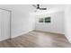 Bright bedroom with a ceiling fan, light wood-look floors, and a double door closet at 1700 Azalea Ct # B, Oldsmar, FL 34677