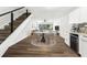 Open dining area with modern staircase, adjacent to kitchen with beverage fridge and backyard access at 1700 Azalea Ct # B, Oldsmar, FL 34677