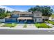 Front exterior of a two-story townhome featuring a covered carport and well-maintained landscaping at 1700 Azalea Ct # B, Oldsmar, FL 34677