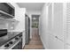 Bright kitchen featuring stainless steel appliances, white cabinets, and a stylish gray subway tile backsplash at 1700 Azalea Ct # B, Oldsmar, FL 34677