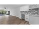 Eat-in kitchen with white cabinets, subway tile backsplash, quartz counters and new appliances at 1700 Azalea Ct # B, Oldsmar, FL 34677
