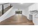 Bright living room with stairs, tile-look floors, a ceiling fan, and sliding glass doors to the backyard at 1700 Azalea Ct # B, Oldsmar, FL 34677