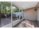 The enclosed patio features a white frame, access to a brick-paved area, and provides a transition to the outdoors at 1700 Azalea Ct # B, Oldsmar, FL 34677
