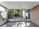 Enclosed patio featuring wood-look flooring, white frame windows, and access to a brick-paved outdoor area at 1700 Azalea Ct # B, Oldsmar, FL 34677