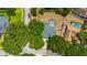 Aerial view of property including a private pool and surrounding mature trees at 18238 Clear Lake Dr, Lutz, FL 33548