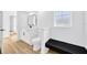 Clean bathroom featuring a white vanity, black hardware, and wood-look floors at 18238 Clear Lake Dr, Lutz, FL 33548