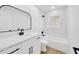 Modern bathroom design with marble-look shower walls and updated fixtures at 18238 Clear Lake Dr, Lutz, FL 33548