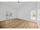 Bright bedroom features wood flooring, a window and sliding doors to a pool area at 18238 Clear Lake Dr, Lutz, FL 33548