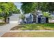 Charming single Gathering home with a beautiful lawn, mature trees, and a two car garage at 18238 Clear Lake Dr, Lutz, FL 33548