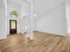 Bright foyer with a high ceiling, laminate wood floors, and a front door with sidelight windows at 18238 Clear Lake Dr, Lutz, FL 33548