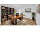 Bright home office featuring a sleek wood desk, modern shelving, and stylish decor at 18238 Clear Lake Dr, Lutz, FL 33548