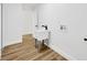 Well-lit laundry room features a utility sink and wood-look vinyl plank flooring at 18238 Clear Lake Dr, Lutz, FL 33548