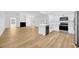 Open-concept living area featuring a modern kitchen with stainless appliances, a fireplace, and wood-look vinyl plank flooring at 18238 Clear Lake Dr, Lutz, FL 33548