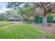 Community playground surrounded by mature trees with picnic tables and lush landscaping at 18238 Clear Lake Dr, Lutz, FL 33548