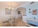 Charming dining area with a glass table, wicker chairs, and light blue walls creating a cozy and inviting atmosphere at 19417 Gulf Blvd # E217, Indian Shores, FL 33785