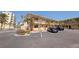 Two-story condo exterior showing convenient parking, a balcony, and palm trees at 19417 Gulf Blvd # E217, Indian Shores, FL 33785
