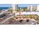 A beachfront condo building with palm trees and parking lot offers easy access to the ocean and resort amenities at 19417 Gulf Blvd # E217, Indian Shores, FL 33785