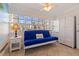Cozy enclosed patio with lots of windows, tile flooring and a blue futon at 19417 Gulf Blvd # E217, Indian Shores, FL 33785