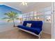 This bright patio features a futon, windows and tile floors at 19417 Gulf Blvd # E217, Indian Shores, FL 33785