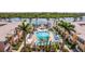 Relax by the beautiful pool with lounge chairs and umbrellas, surrounded by lush landscaping and charming buildings at 19417 Gulf Blvd # E217, Indian Shores, FL 33785