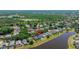 A long aerial view of the home, lake, and treed area in the background at 19505 Morden Blush Dr, Lutz, FL 33558