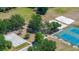 Aerial view of community park featuring basketball court, playground, sand volleyball and tennis courts at 19505 Morden Blush Dr, Lutz, FL 33558