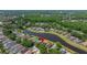 Scenic aerial view of the home located on a small lake with treed area in the distance at 19505 Morden Blush Dr, Lutz, FL 33558