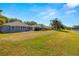 Lush backyard with lake views and palm trees, offering a serene and private setting at 19505 Morden Blush Dr, Lutz, FL 33558