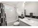 Clean bathroom with tub-shower combo, and black-and-white accents at 19505 Morden Blush Dr, Lutz, FL 33558