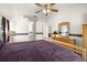 Bright bedroom featuring dresser, and view into ensuite bathroom and closet at 19505 Morden Blush Dr, Lutz, FL 33558