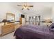 Spacious bedroom with bay window, ceiling fan, and lake views at 19505 Morden Blush Dr, Lutz, FL 33558