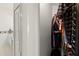 View of hallway showing closet filled with clothes and doorway to bathroom at 19505 Morden Blush Dr, Lutz, FL 33558