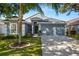 Charming single-story home with a well-manicured lawn and a two-car garage at 19505 Morden Blush Dr, Lutz, FL 33558