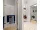Hallway view showing laundry area, storage cabinet, and dining room at 19505 Morden Blush Dr, Lutz, FL 33558