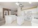 Bright kitchen featuring white cabinets, modern appliances, and a functional center island at 19505 Morden Blush Dr, Lutz, FL 33558