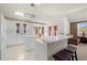 Bright kitchen featuring white cabinets, modern appliances, and a functional center island at 19505 Morden Blush Dr, Lutz, FL 33558