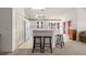 Bright kitchen featuring white appliances and a breakfast bar with seating at 19505 Morden Blush Dr, Lutz, FL 33558
