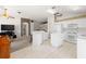 Open-concept kitchen with white cabinetry and seamless transition to the living area at 19505 Morden Blush Dr, Lutz, FL 33558