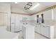 Bright kitchen featuring white cabinets, modern appliances, and a functional center island at 19505 Morden Blush Dr, Lutz, FL 33558