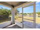 Screened-in lanai offering serene views of the lake and surrounding neighborhood at 19505 Morden Blush Dr, Lutz, FL 33558