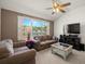 Cozy living room with large windows overlooking a serene lake view at 19505 Morden Blush Dr, Lutz, FL 33558