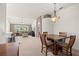 Open-concept dining area with seating for four, leading into a comfortable living room with natural light at 19505 Morden Blush Dr, Lutz, FL 33558