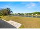 Serene lake view from the patio, showcasing the neighborhood and lush greenery at 19505 Morden Blush Dr, Lutz, FL 33558