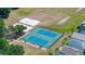 Aerial view of community tennis courts and sand volleyball court with manicured landscaping at 19505 Morden Blush Dr, Lutz, FL 33558